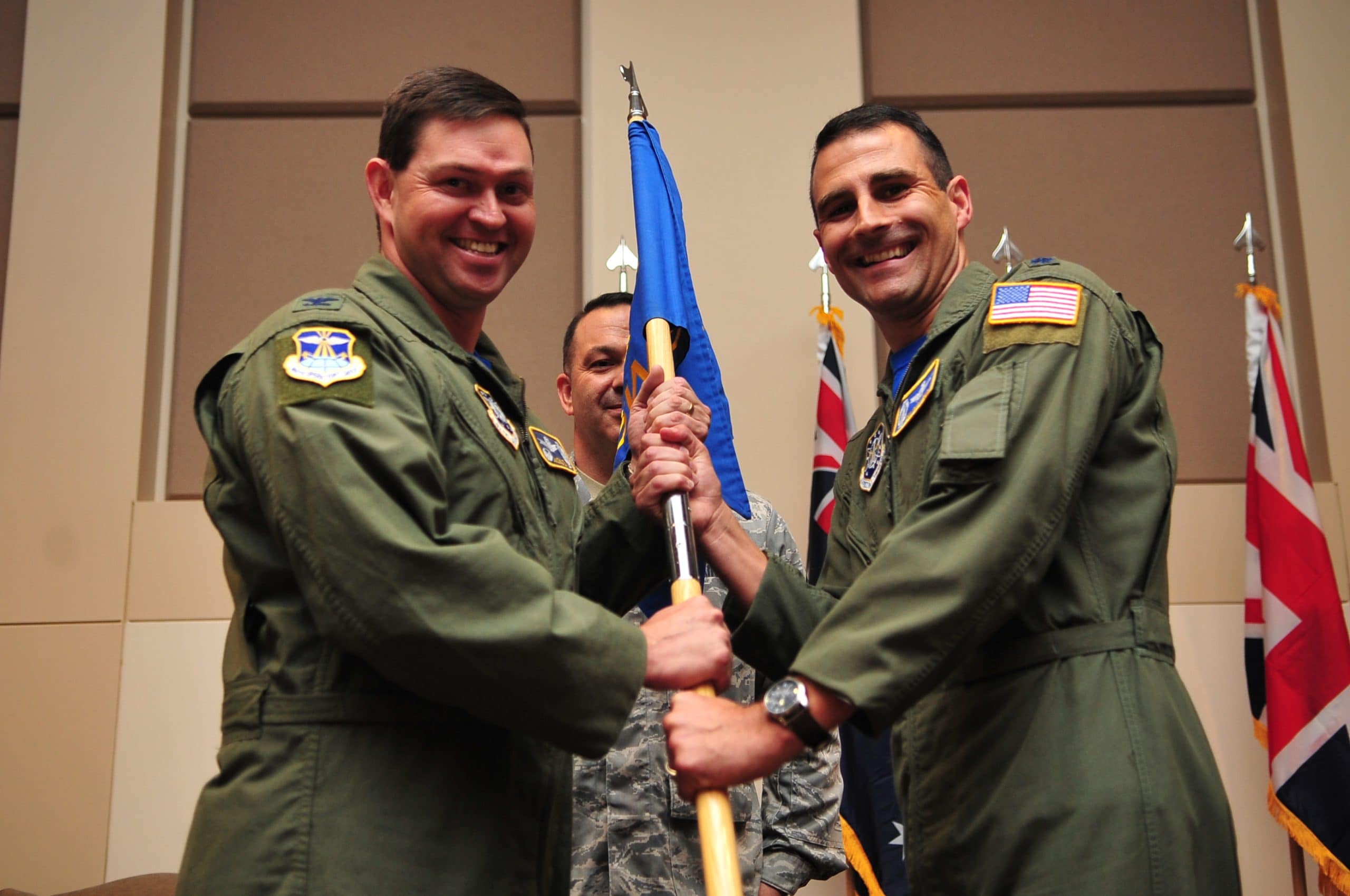 BUCKLEY AIR FORCE BASE, Colo. -- Colonel Bradley Saltzman, 460th Operations Group Commander, presents the flag standard of the 2nd Space Warning Squadron to the incoming commander, Lt. Col. John Henley, June 24, 2011. (U.S. Air Force photo by Staff Sgt. Kathrine McDowell)